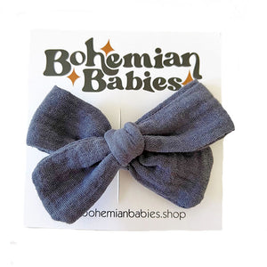 Bohemian Babies. Navy muslin bow on an alligator hair clip mounted on a packaging card for sale
