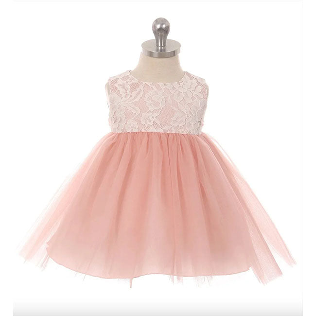 Baby dress in dusty rose. Empire waist with floral lace overlay on bodice. Tulle skirt and bow that ties in back.
