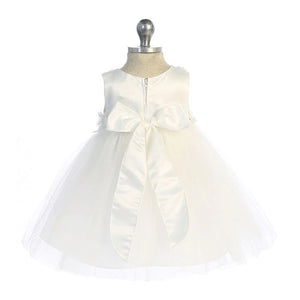 Ivory empire waist baby dress with fabric flower appliques at waist and neckline. Tulle skirt. Back view with satin bow tied at back. 