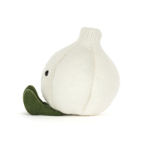 A knitted garlic plush toy in off-white with a dark green stem and leaf, featuring a small black bead eye, shown on a plain white background.