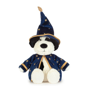 A plush dog toy dressed as a wizard, wearing a navy blue pointed hat and matching robe with gold star patterns and trim, on a plain white background.
