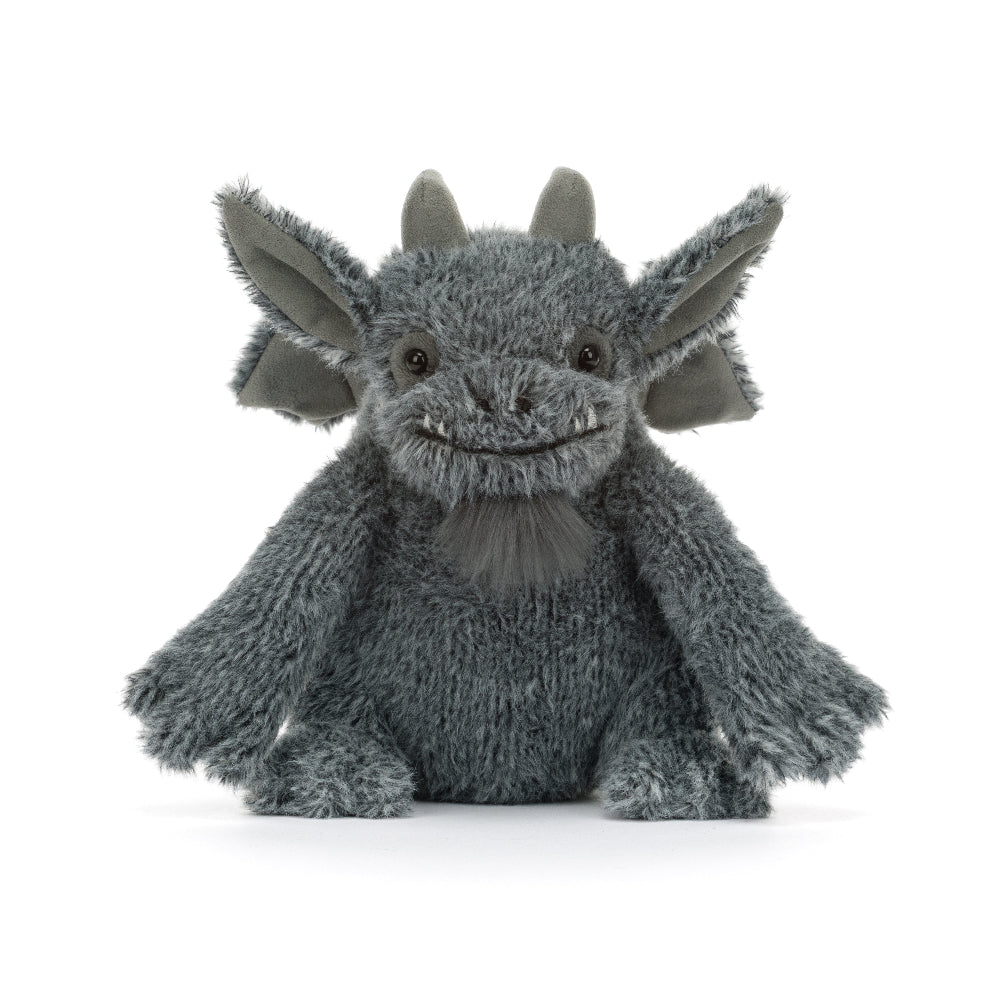 A gray plush dragon toy with large pointed ears, small horns, and a stitched smiling face, photographed against a clean white background.