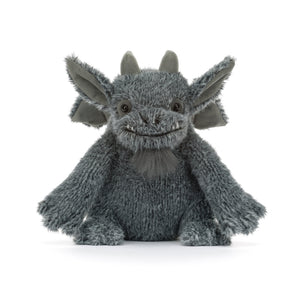 A gray plush dragon toy with large pointed ears, small horns, and a stitched smiling face, photographed against a clean white background.