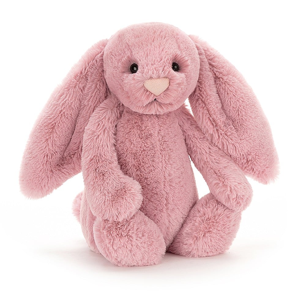 A mauve pink plush bunny with black eyes, lop ears and a pale pink nose.