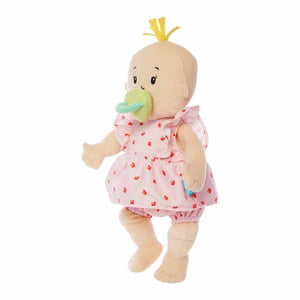 Plush Baby Stella Peach doll with blonde tuft of hair wearing a pink dress and bloomers with cherries print on it. Green magnetic pacifier is attached to doll, as if she is using it. Doll is 15 inches and is standing.