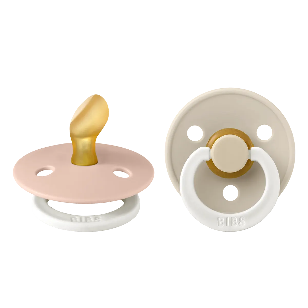 Two baby pacifiers, one beige and one blush with orthodontic nipples, on a white background.