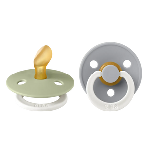 Two baby pacifiers in green and gray with orthodontic latex nipples on a white background