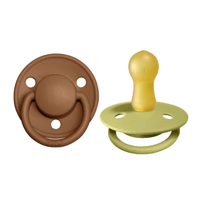 2pk of pacifiers in earth brown and meadow green with round natural latex nipple.