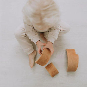 Lifestyle pic of toddler wearing Infant and toddler cuffed jogger lounge pant fleece bamboo cotton in oat.