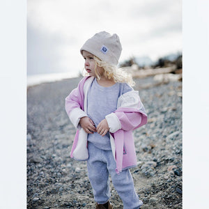 Lifestyle pic of toddler outdoors wearing light grey waffle pant and top.
