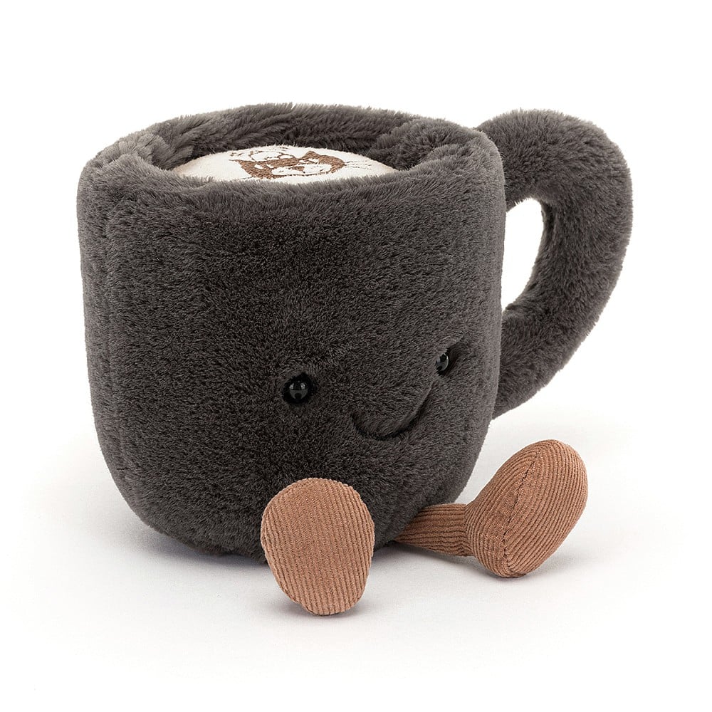 Fuzzy, plush charcoal grey coffee cup with Jellycat logo embroidered in the faux foam on top. Little brown cordy legs and a cheerful smile with shiny black eyes on front of coffee cup.