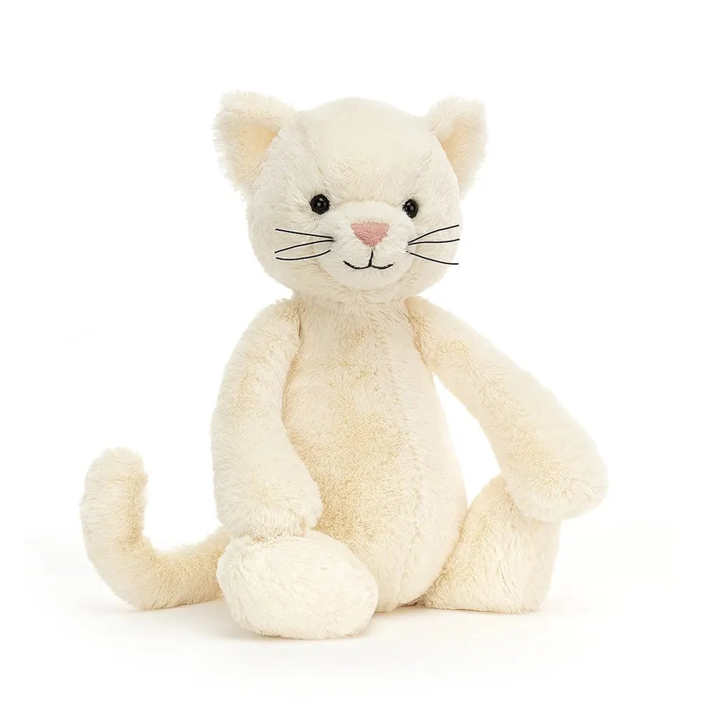 Plush cream coloured cat with black whiskers, eyes and smile.