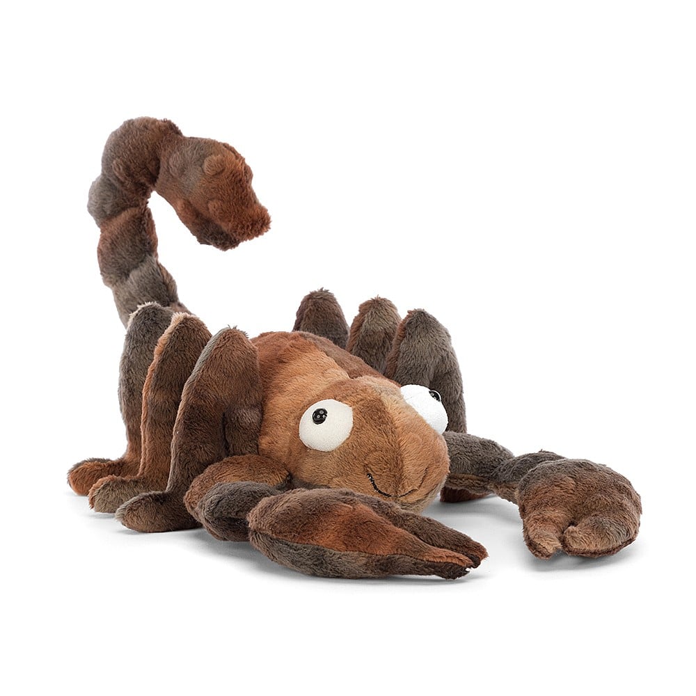 A furry plush scorpion with big eyes and a friendly smile. His plushy fur is mottled shades of brown, and his tail is raised. His furry 'knees'  only add to the adorable look of this usually fearsome arachnid.