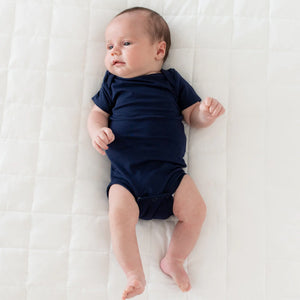 Kyte Baby Short Sleeve Bodysuit in Navy