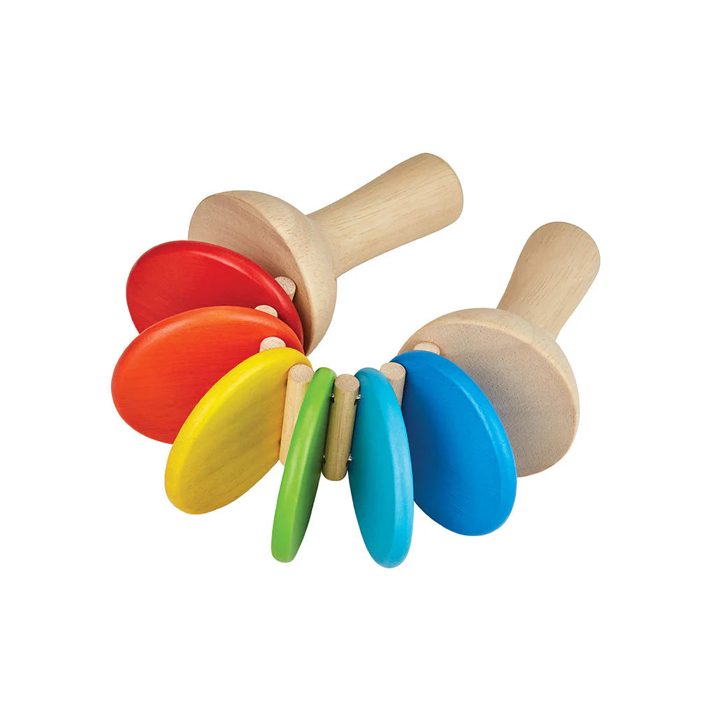 A multicolored noisemaker made of wood on a white background