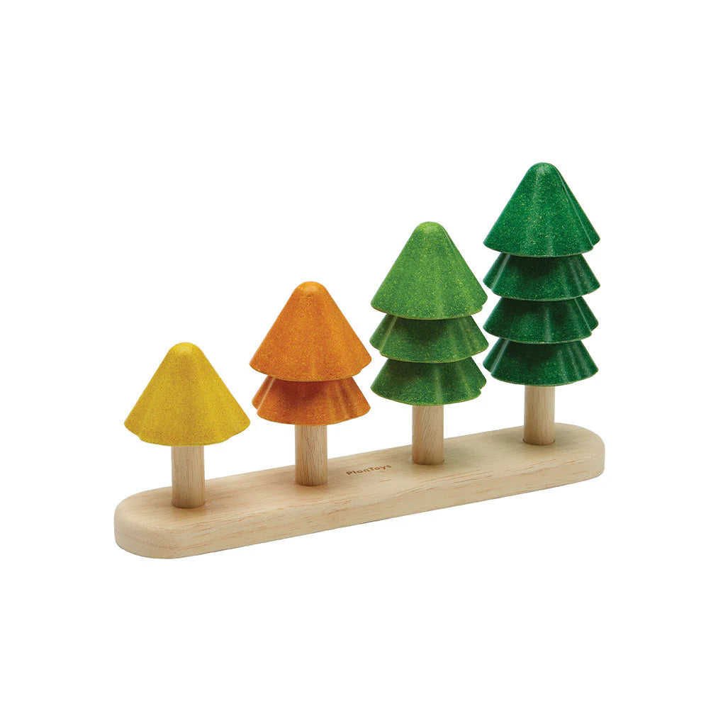 Set of colorful stacking composite rubberwood toy trees on a white background