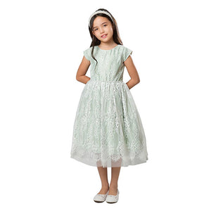 lifestyle pic. Dark-haired girl wearing green special occasion girls dress with floral french lace overlay.